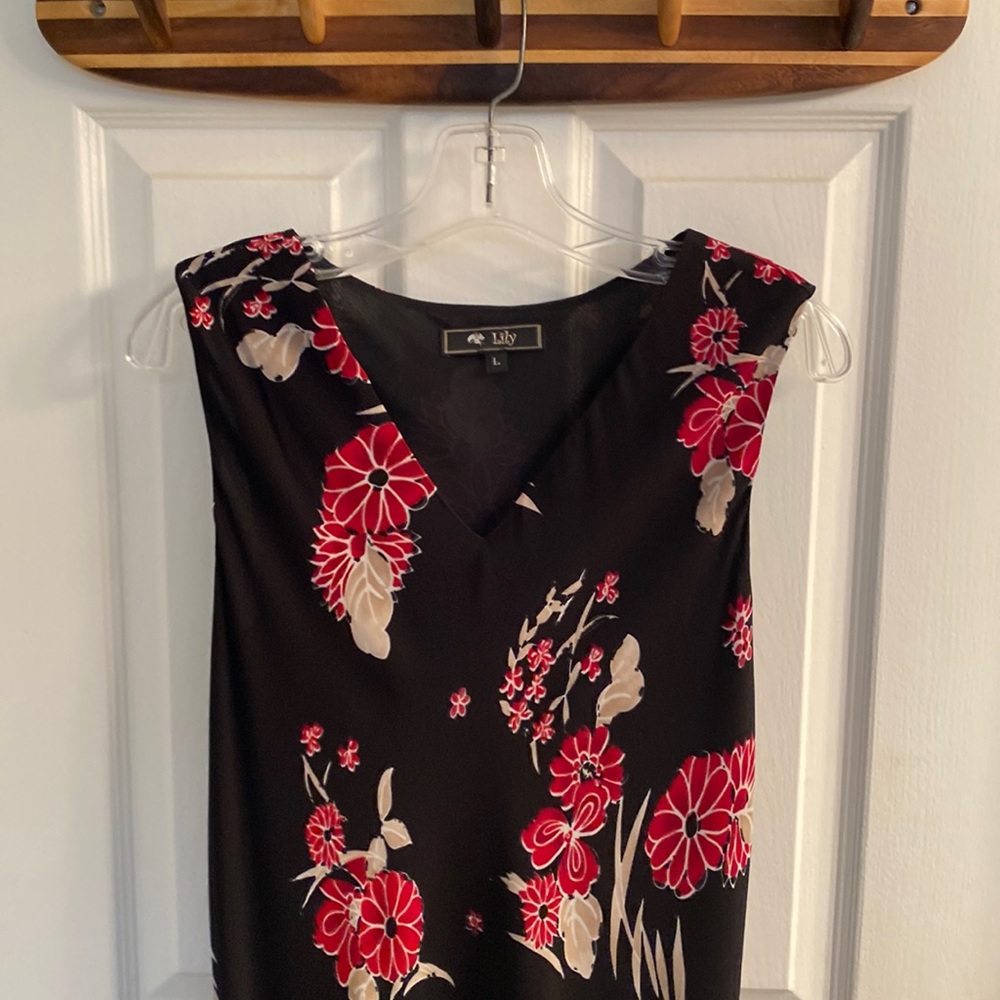Black dress with red flowers and beige leaves.